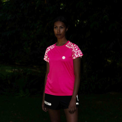 listing-lifestyle Women's Reflective Short Sleeve Training Top pink lights on in garden at night