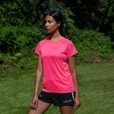 lifestyle Women's Reflective Short Sleeve Training Top pink in garden during day