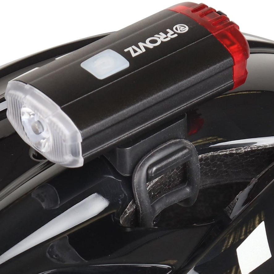 lifestyle A glossy black bicycle helmet with a mounted rear light on top, shown from a three-quarters angle against a plain white background.