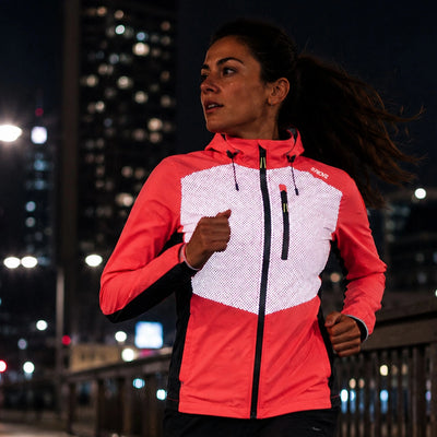 lifestyle Lumina Women’s Reflective Waterproof Running Jacket coral front in city