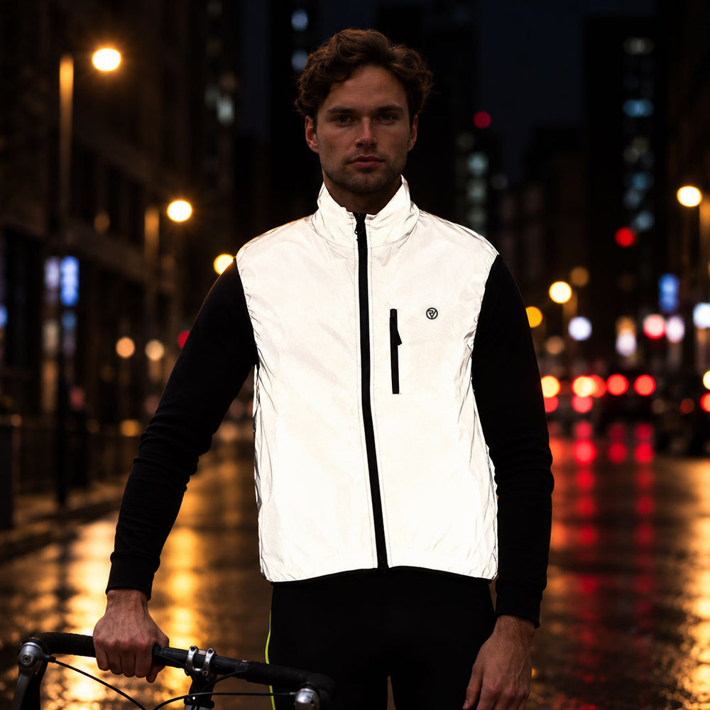 lifestyle men's reversible cycling gilet at night showing the reflectivity