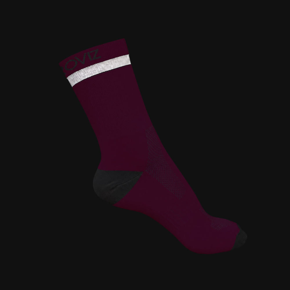 A single crew-length athletic Proviz sock in deep burgundy with a white reflective stripe near the cuff, a dark gray heel section, and a dark gray toe, shown on a black background.