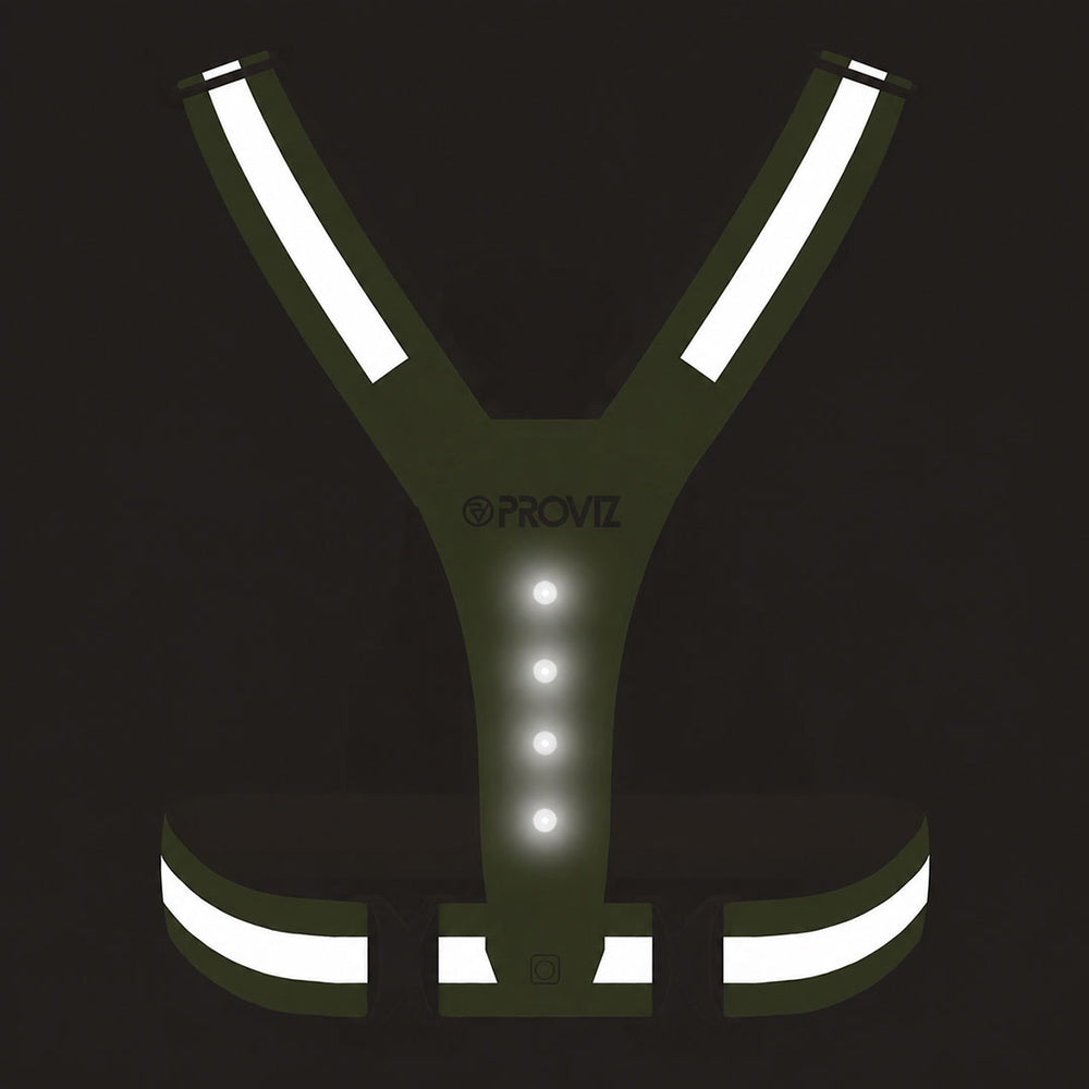 lifestyle A yellow PROVZ reflective safety vest with integrated LED lights, featuring reflective strips on the shoulders and waist, shown on a solid black background.